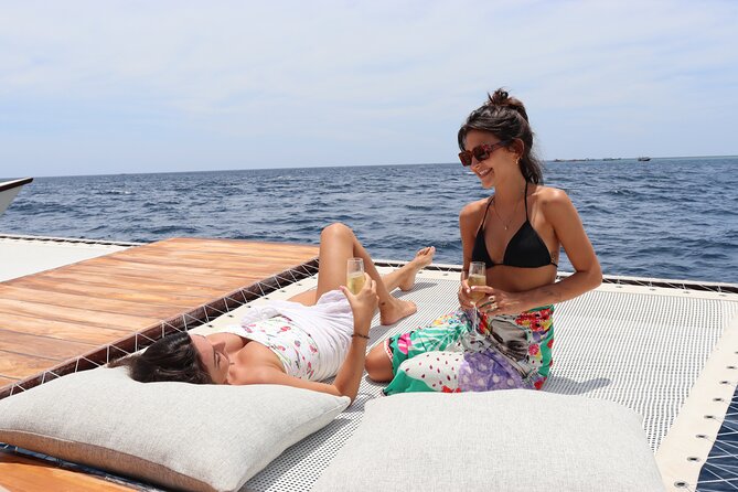 4-in-1 • Gili Islands Snorkel & Sunset Half-day Catamaran Cruise - Deck time, jumping, and the floating beach-club mood